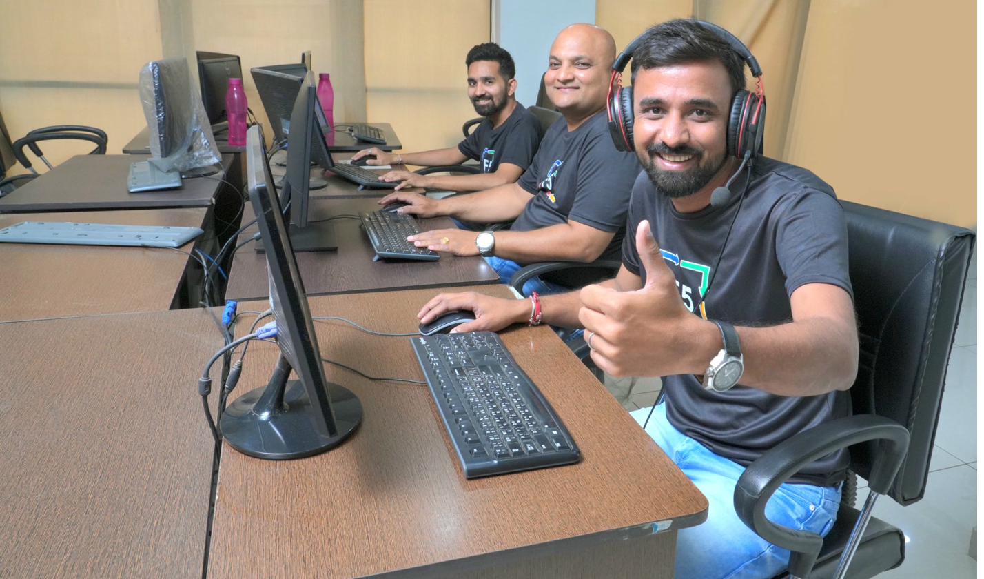 F5 team on the office floor giving a thumbs up.